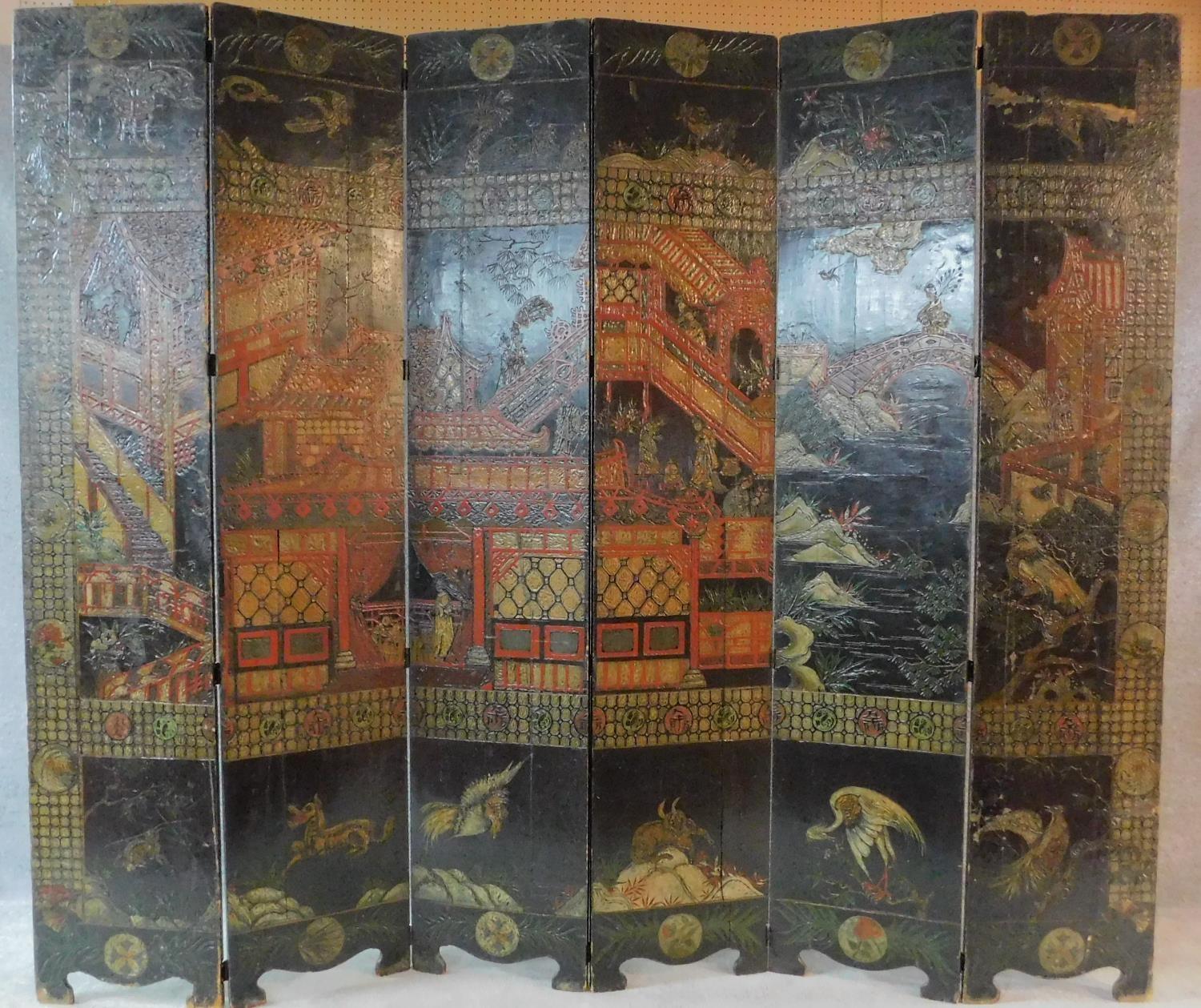 A large six panel screen with five hinged folds with painted and carved Japanese decoration