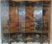 A large six panel screen with five hinged folds with painted and carved Japanese decoration