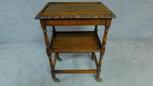 A mid 20th century oak two tier trolley on casters. H. 84cm W. 43cm L. 61cm