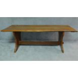 A honey oak refectory dining table with trestle supports. H.76 W.214 H.81cm