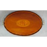 An Edwardian mahogany oval tray with satinwood conch shell inlay and crossbanding with twin brass