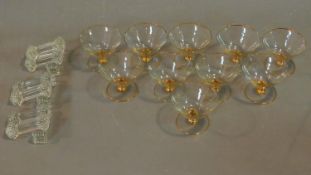 A set of ten vintage champagne bowls and a set of glass knife rests.