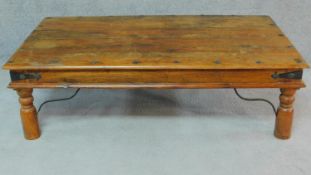 An Indian teak iron bound coffee table. H.41 W.136 D.76cm