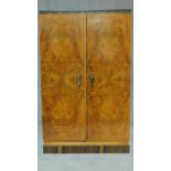 An Art Deco burr walnut and zebra wood inlaid press cupboard fitted with linen drawers. H.124 W.77