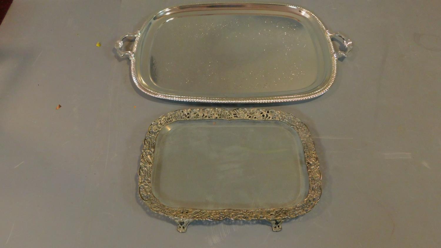 Two silver plated trays, one with glass base and pierced floral and bird design. W.65cm L.41cm