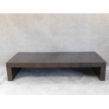 A contemporary low coffee table on block supports. H.30 W.150 D.70cm