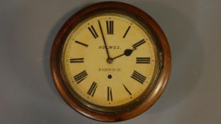 An antique oak wall clock by Holmes of Norwich, with brass banding and roman numerals. 34x34cm