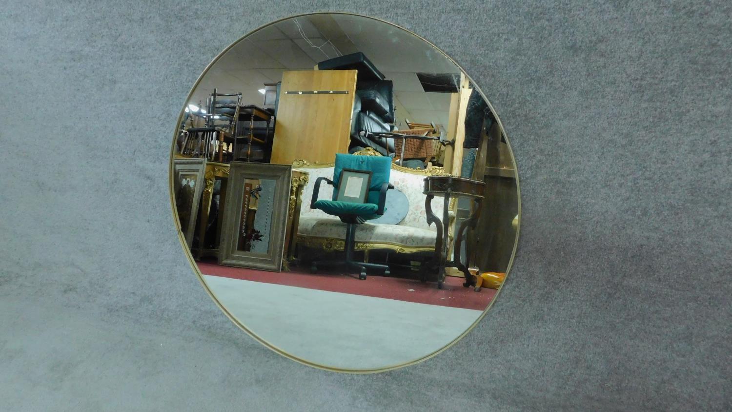 A large circular gilt framed wall mirror. D.91cm