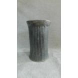 A ribbed hammered metal pedestal stand H.60cm