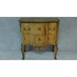 A 19th century Continental commode with floral marquetry inlay, brass lines and ormolu mounts. H.