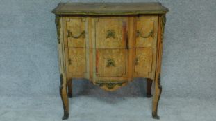 A 19th century Continental commode with floral marquetry inlay, brass lines and ormolu mounts. H.