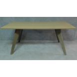 A contemporary limed oak planked top dining table on stained splay supports. H.75 W.180 D.95cm
