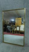 A rectanglar brass framed wall mirror. H.92cm W.61cm