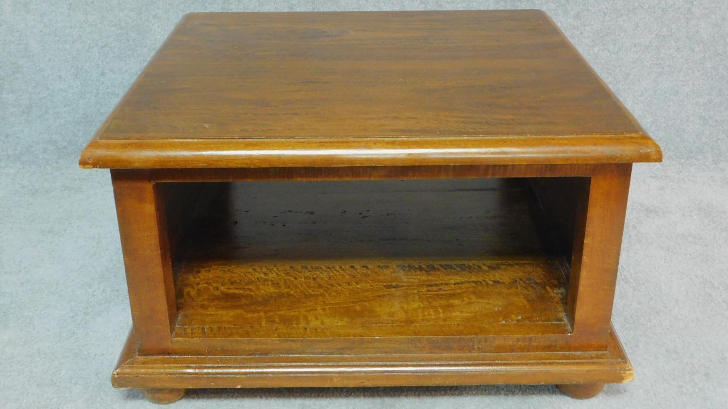A teak low table with undertier. H.41 W.70 D.69cm