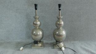 A pair of metal lamp stands of double gourd form. H.61cm