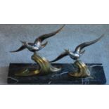 An Art Deco bronze figure group, birds in flight on a marble base, signed TEDD. Birds can be