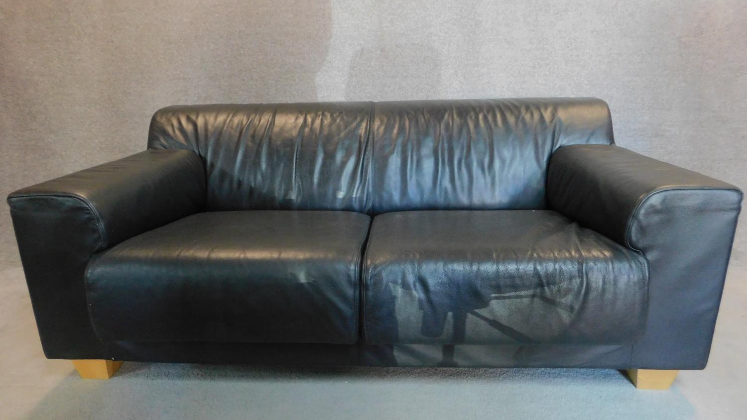 An Italian black leather sofa on solid block feet. 73x177x97cm (bought from Heal's, pair to the - Image 2 of 4