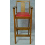 A vintage oak childs high chair. H.98cm