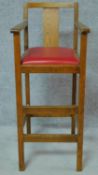 A vintage oak childs high chair. H.98cm