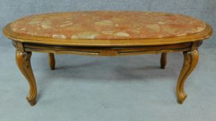 A marble topped continental style coffee table on carved cabriole supports. H.44 W.117 D.63cm