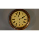 An antique oak wall clock by Holmes of Norwich, with brass banding and roman numerals. 34x34cm
