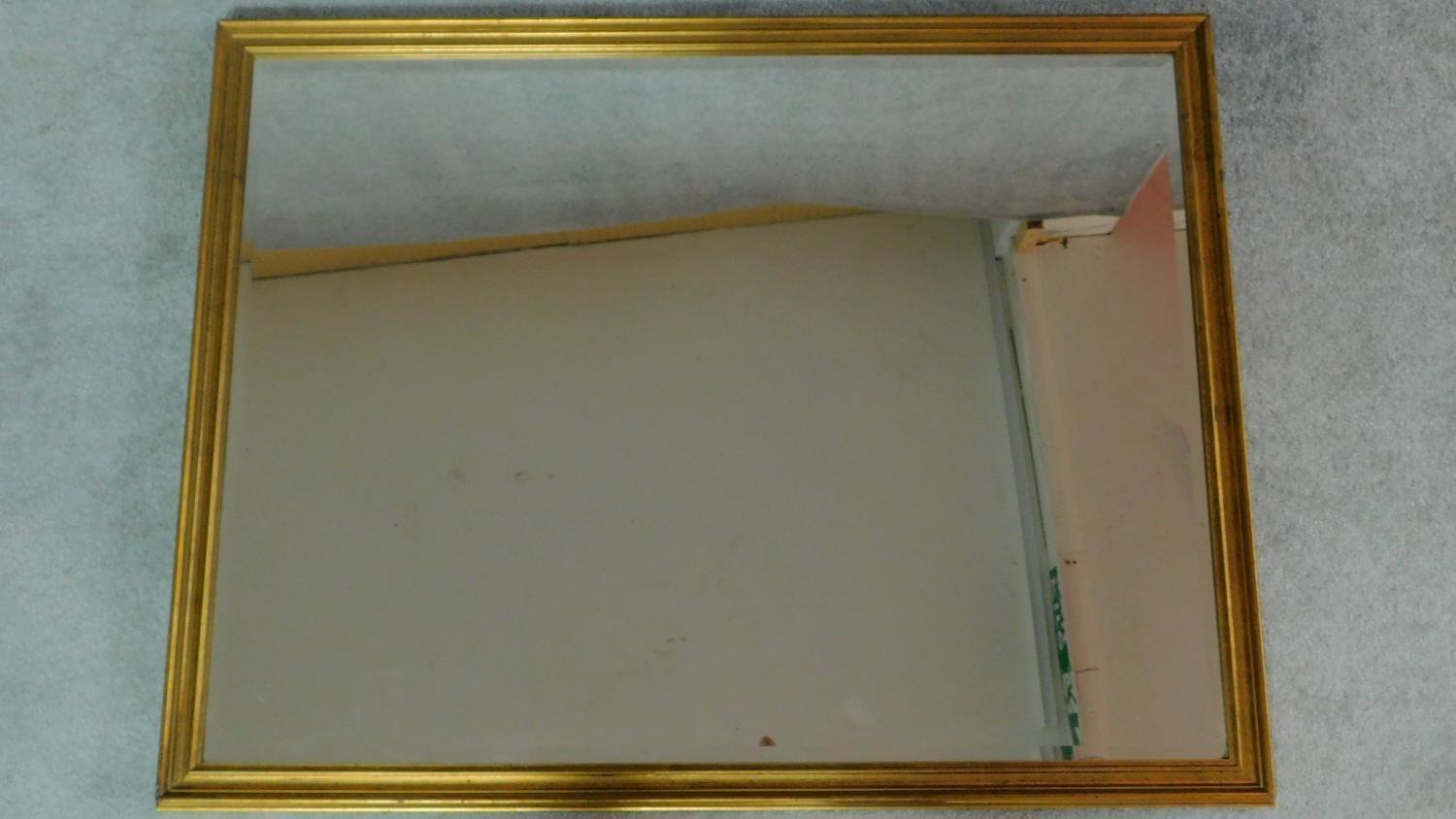 A rectangular gilt framed mirror with bevelled plate. 84x109