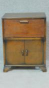 A vintage 1950's oak two door cabinet with drop flap upper section. H.71 W.54 D.37cm