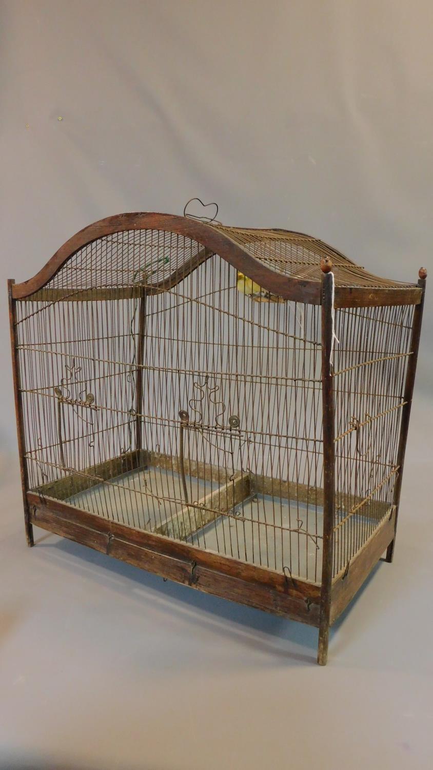 A Victorian style wooden bird cage with exotic birds on perches with wire bars and metal carrying - Image 2 of 5