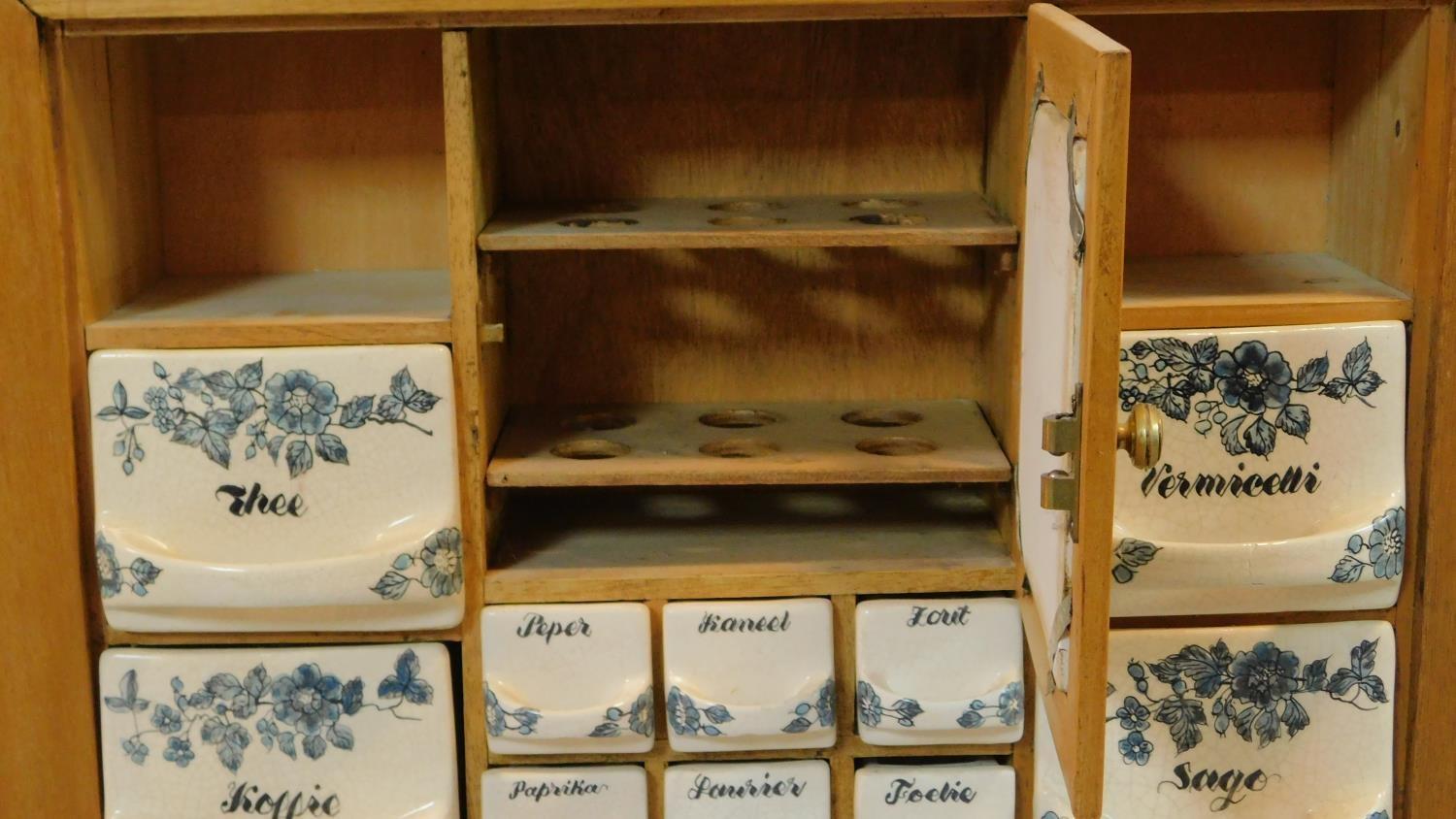 A vintage Dutch herb and spice cabinet with ceramic drawers and door and wooden frame. Central - Image 3 of 3