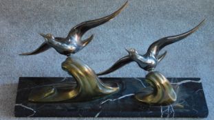 An Art Deco bronze figure group, birds in flight on a marble base, signed TEDD. Birds can be