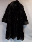 A vintage long black mink fur coat by R C Winterson Ltd. Embroidered name patch to inside with black