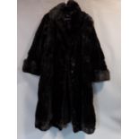 A vintage long black mink fur coat by R C Winterson Ltd. Embroidered name patch to inside with black