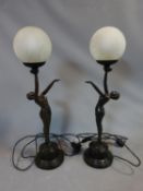 A pair of Art Deco style resin lamps of dancing ladies with crackle glass frosted globe shades. H 67