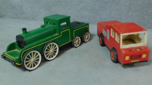Two vintage wooden handmade toy vehicles; a green steam engine and a red fire truck with rubber