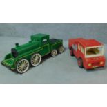 Two vintage wooden handmade toy vehicles; a green steam engine and a red fire truck with rubber