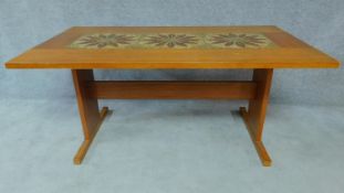 A 1970's vintage teak dining table with ceramic inlaid top. H.72 W.159 D.89cm