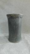 A ribbed hammered metal pedestal stand H.60cm