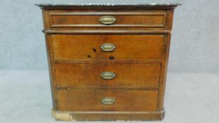 A 19th century Continental walnut commode with grey marble top, fitted four long drawers. H.74 W.