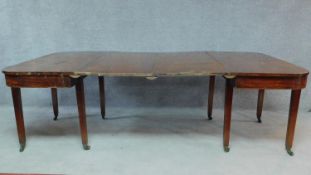 A Georgian mahogany D end dining table with two extra leaves. (missing leaf supports). H.75 W.233