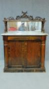 A Regency rosewood chiffonier with dolphin carved mirrored back and marble top above frieze drawer