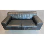 An Italian black leather sofa on solid block feet. 73x177x97cm (bought from Heal's, pair to the