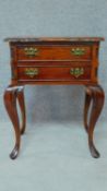 A Georgian style teak two drawer bedside chest on carved cabriole supports. H.68 W.53 D.37cm