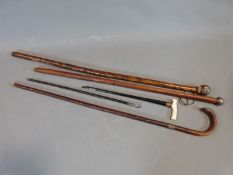 Four antique canes, one with ivory handle and brass engraved collar, two with White metal hammered