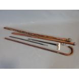 Four antique canes, one with ivory handle and brass engraved collar, two with White metal hammered