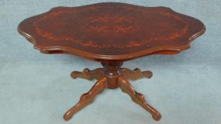 An Italian style mahogany coffee table with shaped and floral inlaid top. H.55 W.99 D.60cm