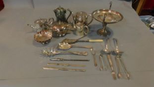 A collection of silver plate including tea pots, bone marrow spoons, sugar tongs, bonbon dish and