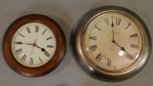 Two Victorian style wall clocks, one with wooden surround and one with antique metal finish. Both