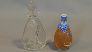 A Chinese ceramic vase and cut glass decanter. Vase with blue and white decoration of birds among