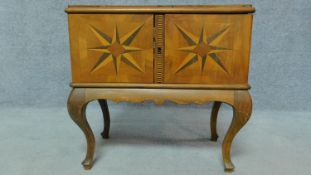A Continental walnut fitted specimen cabinet with parquetry chequer and starburst inlay. H.56 W.57
