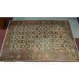 A Persian Tabriz rug with allover floral motifs on a cream ground within floral multi borders